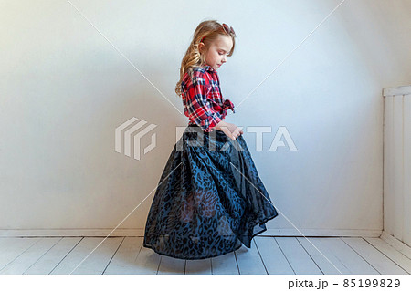 Sweet happy adorable fashion young little girl dressed like hipster hippie gipsy cowboy in sunglasses standing against white wall background in light bright room. Lifestyle people trendy concept Sweet happy adorable fashion young little girl dressed like hipster hippie gipsy cowboy in sunglasses standing against white wall background in light bright room. Lifestyle people trendy concept 85199829