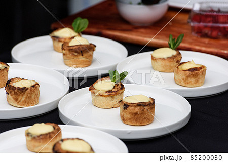 Typical Portuguese custard pies Pastel de Nata or Pastel de Belem. traditional portuguese pastry. On a black tablecloth 85200030