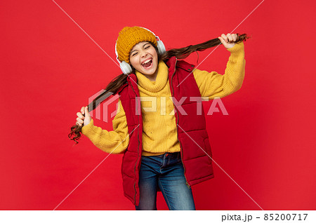 shouting kid in hat listen music in earphones holding hair, fun 85200717