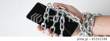 Male hands tied with chain and hold smartphone 85201586