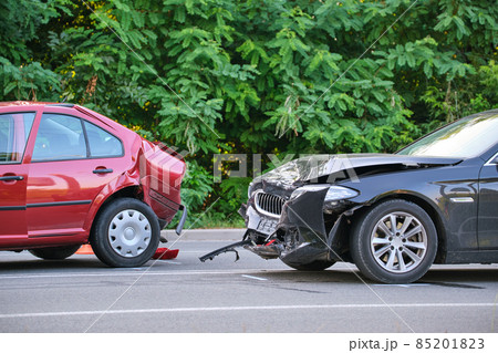 Damaged in heavy car accident vehicles after collision on city street crash site. Road safety and insurance concept. 85201823