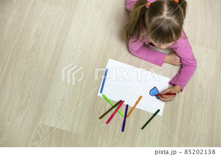 Child girl drawing with colorful pencils crayons heart on white paper. Art education, creativity concept. 85202138