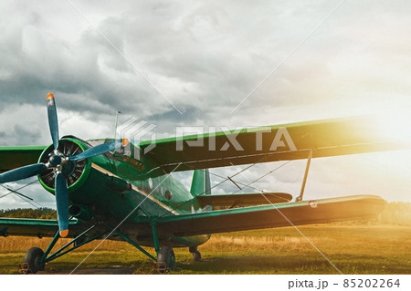 Vintage aircraft preparing for take-off on the background of a stormy sky Vintage aircraft preparing for take-off on the background of a stormy sky 85202264