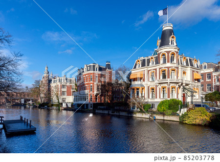 Beautiful old houses on the city waterfront of Amsterdam on a sunny day. Beautiful old houses on the city waterfront of Amsterdam on a sunny day. 85203778