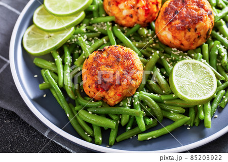 Prawn and Crab Cakes on a plate with green beans Prawn and Crab Cakes on a plate with green beans 85203922