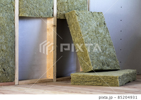 Wooden frame for future walls with drywall plates insulated with rock wool and fiberglass insulation staff for cold barrier. Comfortable warm home, economy, construction and renovation concept. 85204931