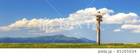 Tourist paths directions shown on a traditional direction sign in mountains. 85205034