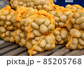 Potatoes for sale at vegetable market, close up. Boxes full of potatoes in shop. Fresh potato at the greengrocer's stall.   85205768