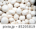 Fresh mushrooms for sale at vegetable market, close up. Boxes full of mushrooms in shop. Champignon at the greengrocer's stall. Agaricus bisporus 85205819