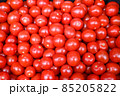 Red tomatoes for sale at vegetable market, close up. Boxes full of tomatoes in shop. Fresh tomato at the greengrocer's stall. Ripe tomatoes on table. Vegetable. 85205822