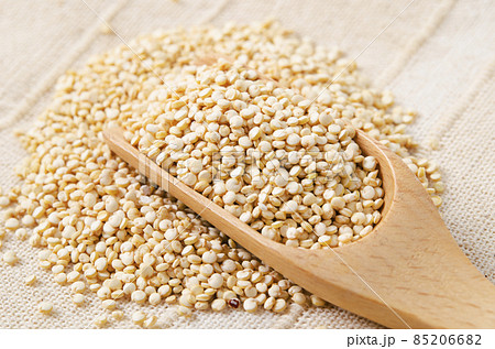 Raw, whole, unprocessed quinoa seed in wooden spoon. Raw, whole, unprocessed quinoa seed in wooden spoon. 85206682
