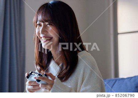 ソファの上でテレビゲームをする女性 ソファの上でテレビゲームをする女性 85206790