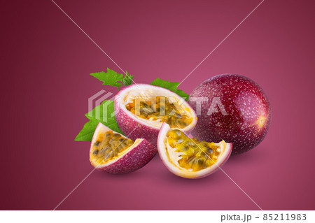 Whole passionfruit and a half of maracuya isolated on red background. 85211983