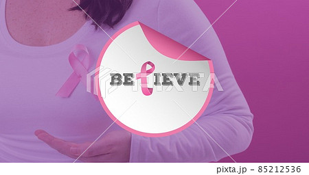 Composition of woman with breast cancer awareness ribbon and believe text against pink background 85212536