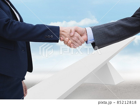 Mid section of two businessmen shaking hands over seesaw against clouds in the sky Mid section of two businessmen shaking hands over seesaw against clouds in the sky 85212818