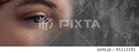 Composite image of close up of a female eye and grunge effect over wooden background Composite image of close up of a female eye and grunge effect over wooden background 85213392