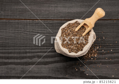 pouch full of Organic natural chia seeds on dark wooden background or table pouch full of Organic natural chia seeds on dark wooden background or table 85215621