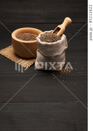 pouch full of Organic natural chia seeds on dark wooden background or table 85215622