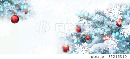 Christmas tree background with shiny blurred light, red xmas balls decoration in fir tree with copy space 85216310