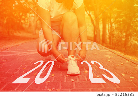 Cropped image of sports women hands tying laces off white sneakers outdoor for the run training, healthy exercise workout concept. Idea and creative in 2022 Cropped image of sports women hands tying laces off white sneakers outdoor for the run training, healthy exercise workout concept. Idea and creative in 2022 85216335