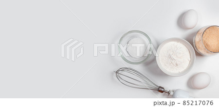 Ingredients and utensils for baking on white background. Mockup of a pie or cake with cookies recipe Ingredients and utensils for baking on white background. Mockup of a pie or cake with cookies recipe 85217076