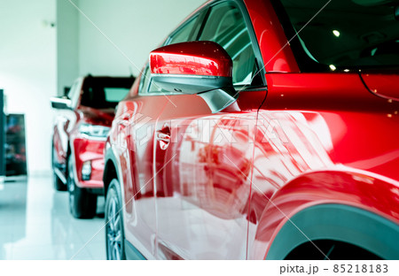 Selective focus red car parked in luxury showroom. Car dealership office. New car parked in modern showroom. Car for sale and rent business concept. Automobile leasing and insurance background. 85218183