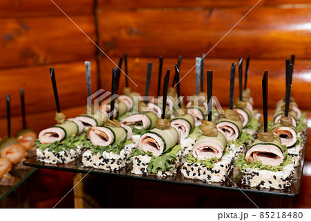 Snacks with sausage, cheese, lard and various sauces at a Ukrainian wedding. 85218480