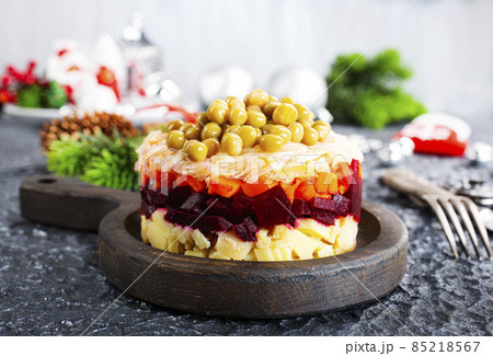 Salad of beets, carrots, potatoes, onions and green peas. Traditional Russian beetroot salad. Vegetarian vegetable salad. 85218567