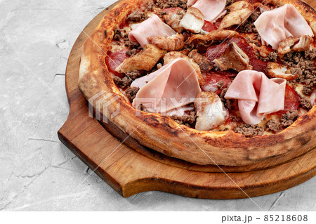 Meat Italian pizza with roast beef, steak slices, melted cheese, with olive slices and cheddar cheese. Close up, macro. Pizza time concept. Meat Italian pizza with roast beef, steak slices, melted cheese, with olive slices and cheddar cheese. Close up, macro. Pizza time concept. 85218608