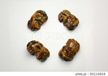 Natural tiger eye pet carving on the white background Natural tiger eye pet carving on the white background 85219828