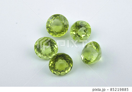 Natural round green peridot on the white background 85219885