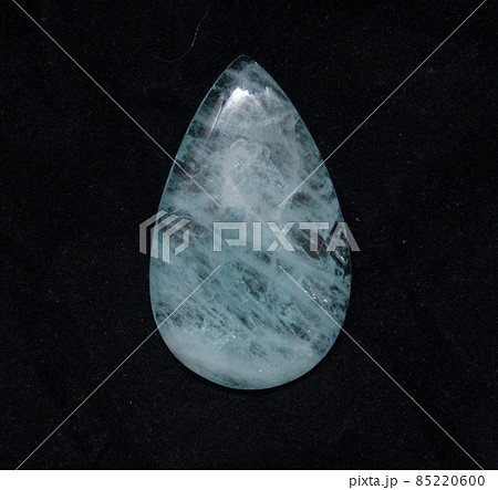 Natural blue aquamarine pear cabochon on the black background 85220600