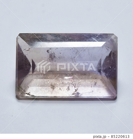 Natural yellow and purple ametrine on the white background 85220613
