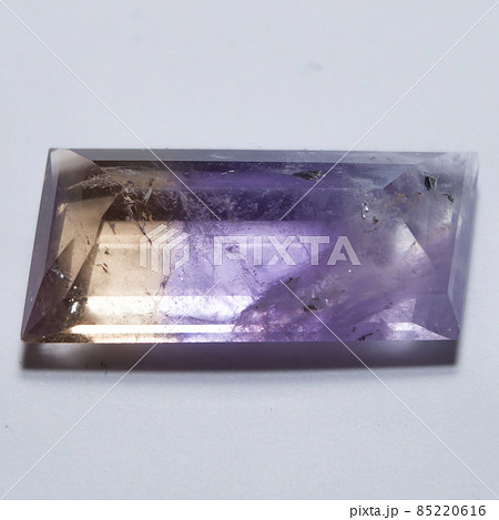 Natural yellow and purple ametrine on the white background 85220616
