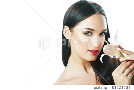 young attractive lady close up with hands on face isolated flower lily brunette spa nude makeup, beauty concept 85223582