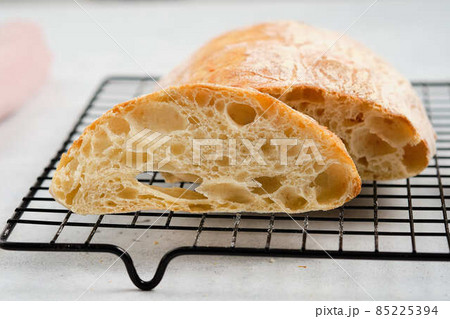 Homemade ciabatta cools down on a wire rack. Homemade ciabatta cools down on a wire rack. 85225394