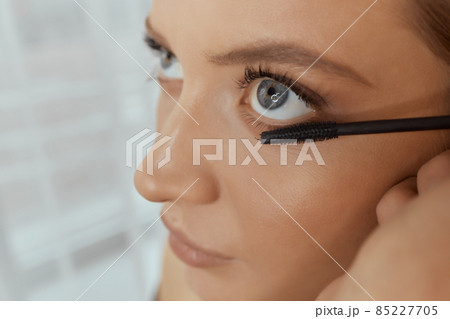Eyelash Extension Procedure. Woman Eye with Long Eyelashes. Lashes. Close up, selected focus. 85227705