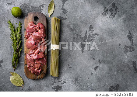 Fresh chicken liver and ingredients, on gray stone table background, top view flat lay, with copy space for text 85235383