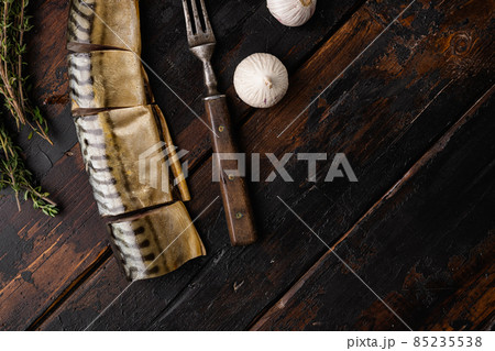 Smoked mackerel, on old dark wooden table background, top view flat lay, with copy space for text 85235538