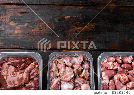 Raw turkey hearts offal stomach in pack, on old dark wooden table background, top view flat lay, with copy space for text Raw turkey hearts offal stomach in pack, on old dark wooden table background, top view flat lay, with copy space for text 85235540