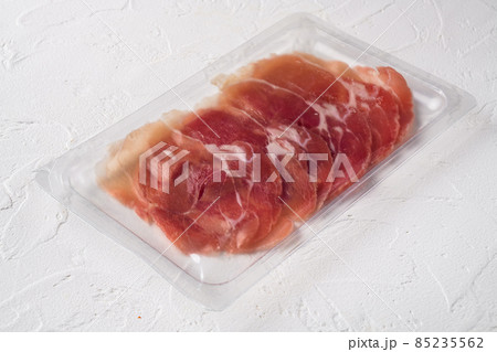Cured ham jamon vacuum plastic pack, on white stone table background, with copy space for text Cured ham jamon vacuum plastic pack, on white stone table background, with copy space for text 85235562