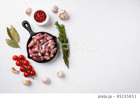 Raw poultry hearts offal with herbs, on white stone table background, top view flat lay, with copy space for text Raw poultry hearts offal with herbs, on white stone table background, top view flat lay, with copy space for text 85235651