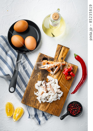 Spanish or Thai omelette ingredient, fresh red chilli, brown and white crabmeat, lemon, Cheddar cheese, eggs, on white background, top view flat lay 85235819