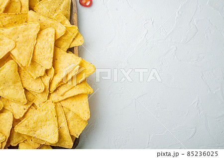 Mexican crispy snack, nachos chips and cheese guacamole avocado sauce, on white background, top view or flat lay with copy space for text 85236025