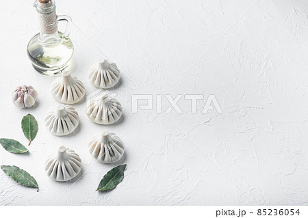 Uncooked Baozi chinese dumplings. Azian dumplings, on white stone surface, with copy space for text Uncooked Baozi chinese dumplings. Azian dumplings, on white stone surface, with copy space for text 85236054