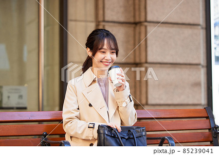 ベンチでコーヒーを飲む女性 85239041