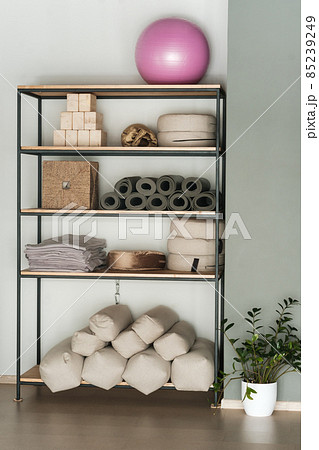 Sports equipment for yoga classes is on the shelf in the gym Sports equipment for yoga classes is on the shelf in the gym 85239249