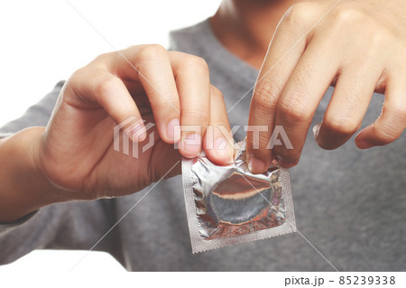 Condom ready to use in female hand, give safe sex concept on the bed Prevent infection and Contraceptives control the birth rate or safe prophylactic. World AIDS Day, Condom ready to use in female hand, give safe sex concept on the bed Prevent infection and Contraceptives control the birth rate or safe prophylactic. World AIDS Day, 85239338