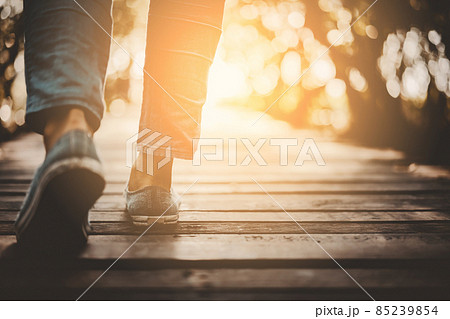 Close up woman walk in to the wild with sunset and sunlight background. Close up woman walk in to the wild with sunset and sunlight background. 85239854