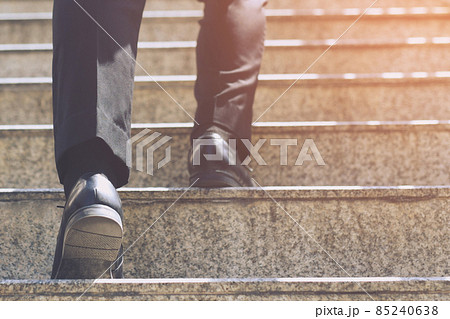 Close up legs shoes of young business man One person walking stepping going up the stairs in modern city, go up, success, grow up. with filter Tones retro vintage warm effect. stairway 85240638